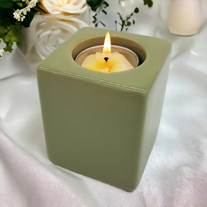 Contemporary olive green ceramic tealight holder square shape with lit white tea light high x 7cm size