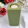 Olive green ceramic tealight holder with circular cutout holding white candle high x 7cm contemporary design