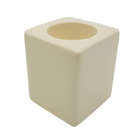 Cream-colored ceramic tealight holder with square shape and rounded edges in a contemporary ivory design