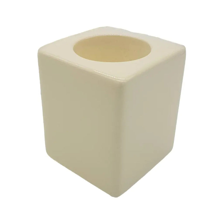 Cream-colored ceramic tealight holder with square shape and rounded edges in a contemporary ivory design