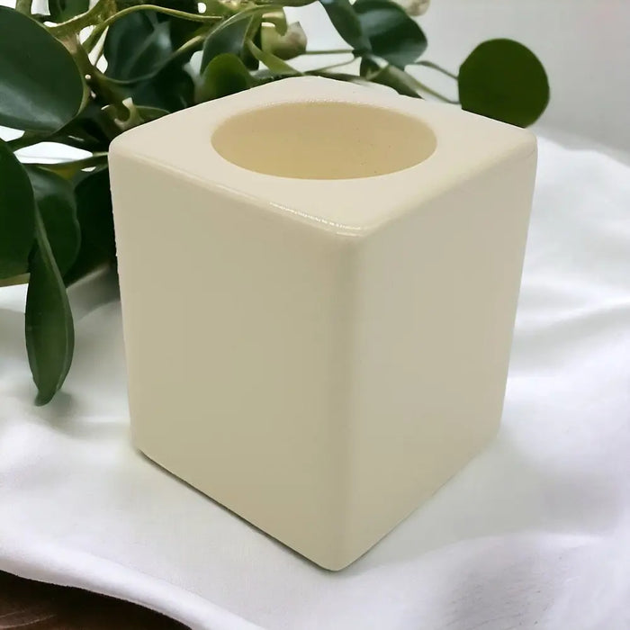 Contemporary ivory square ceramic tealight holder with a smooth glossy finish and rounded edges for candles