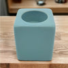 A sleek pale blue ceramic tealight holder with a matte finish and square shape measuring high x 7cm