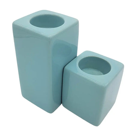 Two pale blue matte ceramic tealight holders in rectangular high x 7cm and cube shapes for modern decor