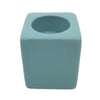 A pale blue matte ceramic tealight holder with a square shape and rounded edges, high x 7cm size visible