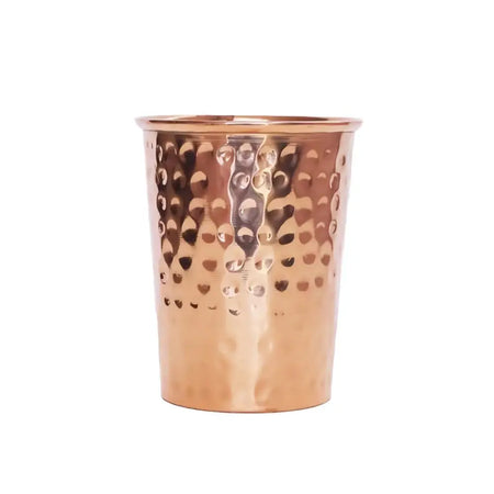 A hammered copper water cup 300ml with a smooth reflective surface and evenly spaced circular indentations
