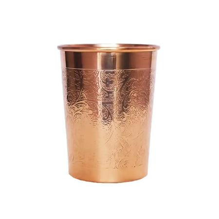A copper water cup 300ml with intricate floral embossing made of copper for drinking water use