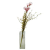 A clear rectangular glass vase holding dusky pink artificial wild flowers with fluffy petals and slender green stems