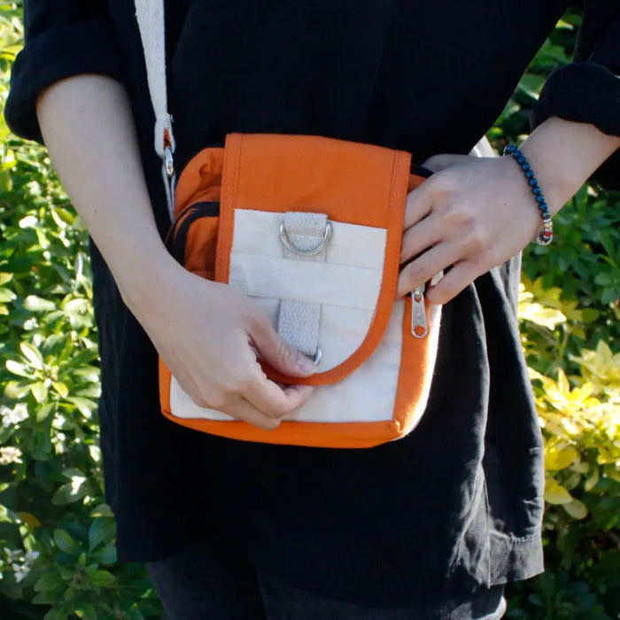 Orange and white cotton body bag with silver metal d-ring and zipper pull in a crossbody style called turmeric