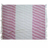 A handwoven cotton throw with a central white stripe and ruby pink patterned sections with fringed edges