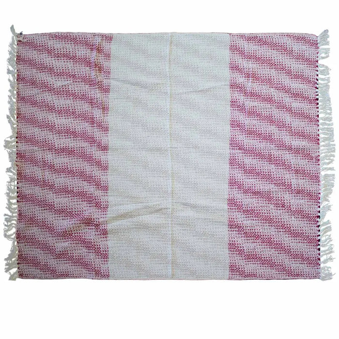 A handwoven cotton throw with a central white stripe and ruby pink patterned sections with fringed edges