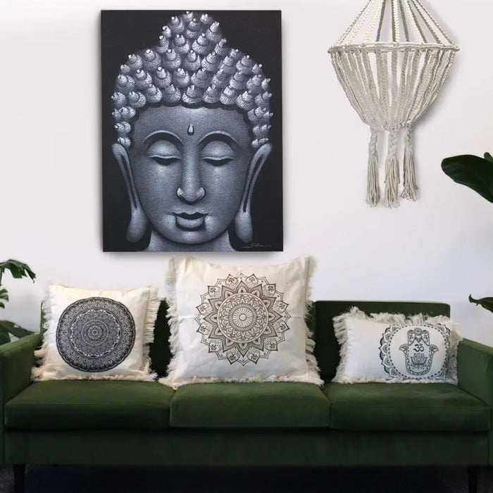 Black and silver buddha canvas art with intricate dot detailing on a cotton cushion cover with traditional mandala design