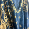 A navy blue cotton kaftan with gold foil patterns and a gold sequin trim along the linen neckline
