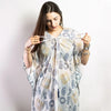 A flowing white cotton kaftan with navy blue and gold geometric and circular motifs inspired by greek design