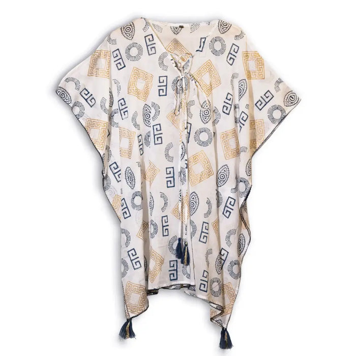 A flowing off-white cotton kaftan with gold and navy blue geometric patterns and tassels at the hem