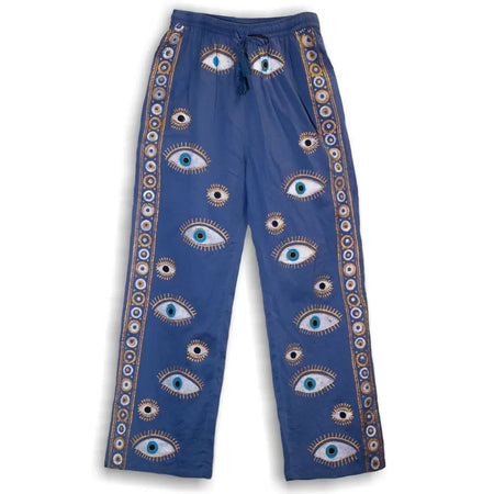 Blue cotton lounge pants with evil eye embroidery and gold white circular trim inspired by nomad sari style