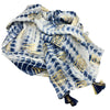 A lightweight cotton pareo with blue and white tie dye and gold block print motifs finished with navy tassels