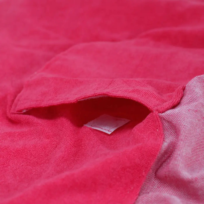 A cotton pario towel in vibrant hot pink with soft terry cloth texture and neatly stitched edges