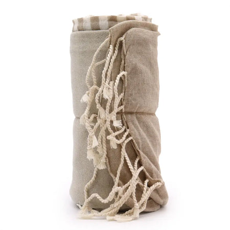 Beige cotton pario towel with cream braided rope tassels and striped pattern at the top in warm sand color
