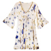 White cotton print dress with v-neck and bell sleeves featuring blue and gold evil eye and nomad sari motifs