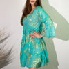 A flowing turquoise cotton print dress with gold leaf patterns and bell sleeves in m/l size coral and gold details