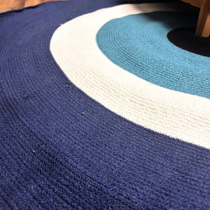 Cotton rope circular woven rug with evil eye design in navy blue cream white and teal measuring 150cm