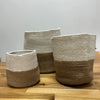 Set of three cotton rope storage baskets in white and natural brown with woven textured rope material