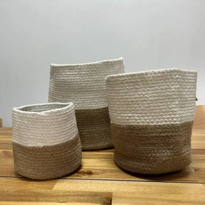 Set of three cotton rope storage baskets in white and natural brown with woven textured rope material