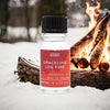 A clear glass bottle with black cap and red label of crackling log fire fragrance oils 10ml with allergen declarations