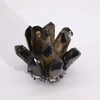 A quartz cluster of dark smoky ghost quartz crystals with translucent faceted points on a rough mineral base