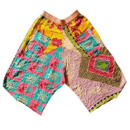 Cropped kantha trousers with colorful quilted patchwork in yellow pink teal and black featuring a pink waistband