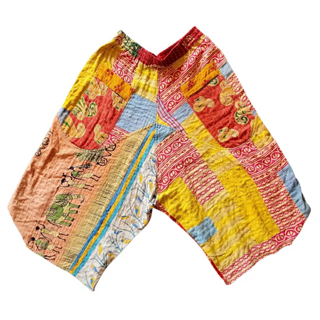 Cropped kantha trousers with vibrant patchwork in red yellow blue and orange on soft cotton with red waistband