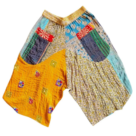 Cropped kantha trousers with a yellow waistband and patchwork fabric in blue beige and embroidered geometric patterns