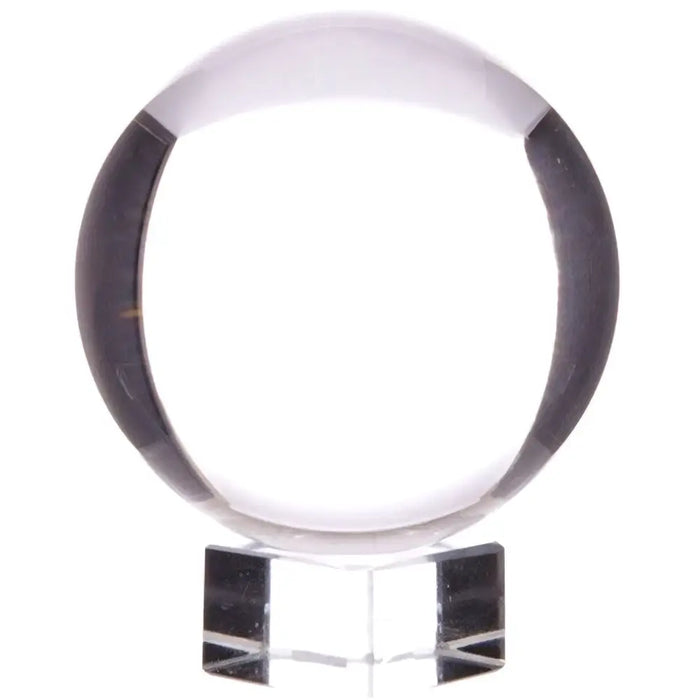 Crystal ball on stand with dark band encircling clear optical glass resting on a transparent acrylic base 200mm