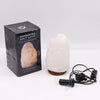 A white crystal rock himalayan salt lamp with rough texture and brown ceramic base showing hygroscopic properties