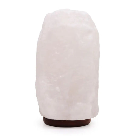 A translucent white crystal rock himalayan salt lamp with rough texture and dark brown base showing hygroscopic properties