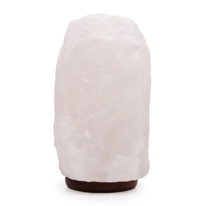 A translucent white crystal rock himalayan salt lamp with rough texture and dark brown base showing hygroscopic properties