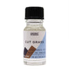 A clear glass bottle of cut grass fragrance oil with black cap labeled ancient wisdom contains light liquid