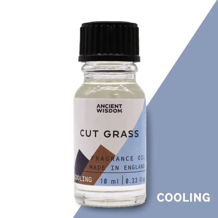 A clear glass bottle with black cap containing light cut grass fragrance oil labeled ancient wisdom with allergen declarations