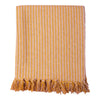 A cozy recycled cotton striped throw in pale pink and mustard with a textured weave and matching tassels