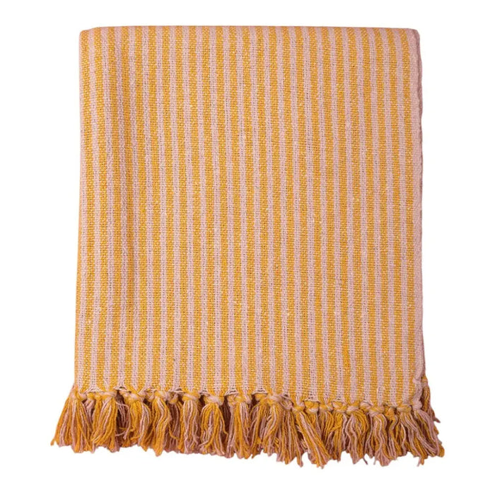 A cozy recycled cotton striped throw in pale pink and mustard with a textured weave and matching tassels