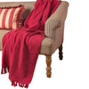 A vibrant red and pink striped throw made of recycled cotton with a ribbed texture and tassels at the ends