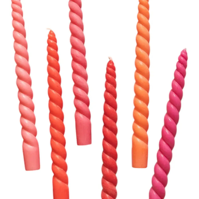 Daisy snow six twisted dinner candles in coral orange and pink hues with smooth coconut oil wax finish