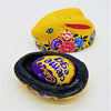 Yellow dalit goods rabbit trinket box in kashmiri style with floral patterns holding a cadbury creme egg inside black interior