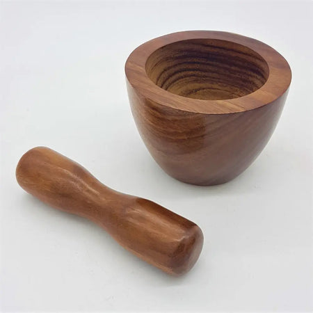 A smooth polished sheesham wood mortar and pestle set with a rich brown finish from Dalit Goods Co