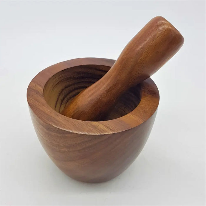 A smooth rich brown sheesham wood mortar and pestle set with rounded bowl and matching handle by dalit goods