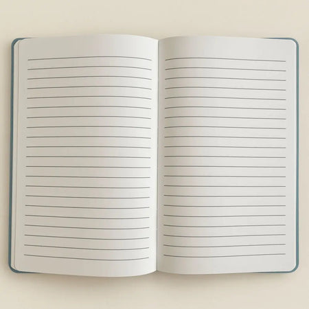 Open notebook with lined pages and a dark blue velvet cover from the stay wild moon child blue velvet notebook series
