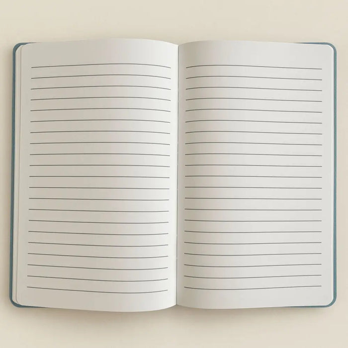 Open notebook with lined pages and a dark blue velvet cover from the stay wild moon child blue velvet notebook series