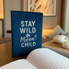 Dark blue velvet notebook with 80 pages featuring stay wild moon child in white lettering and a globe design