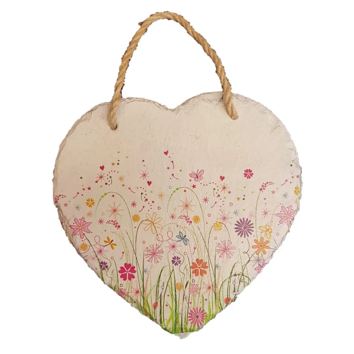 A rustic heart-shaped slate plaque with a bright pink orange and yellow floral design for découpage decor