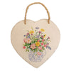 A heart-shaped slate plaque with a floral design in a blue and white vase hanging from natural twine